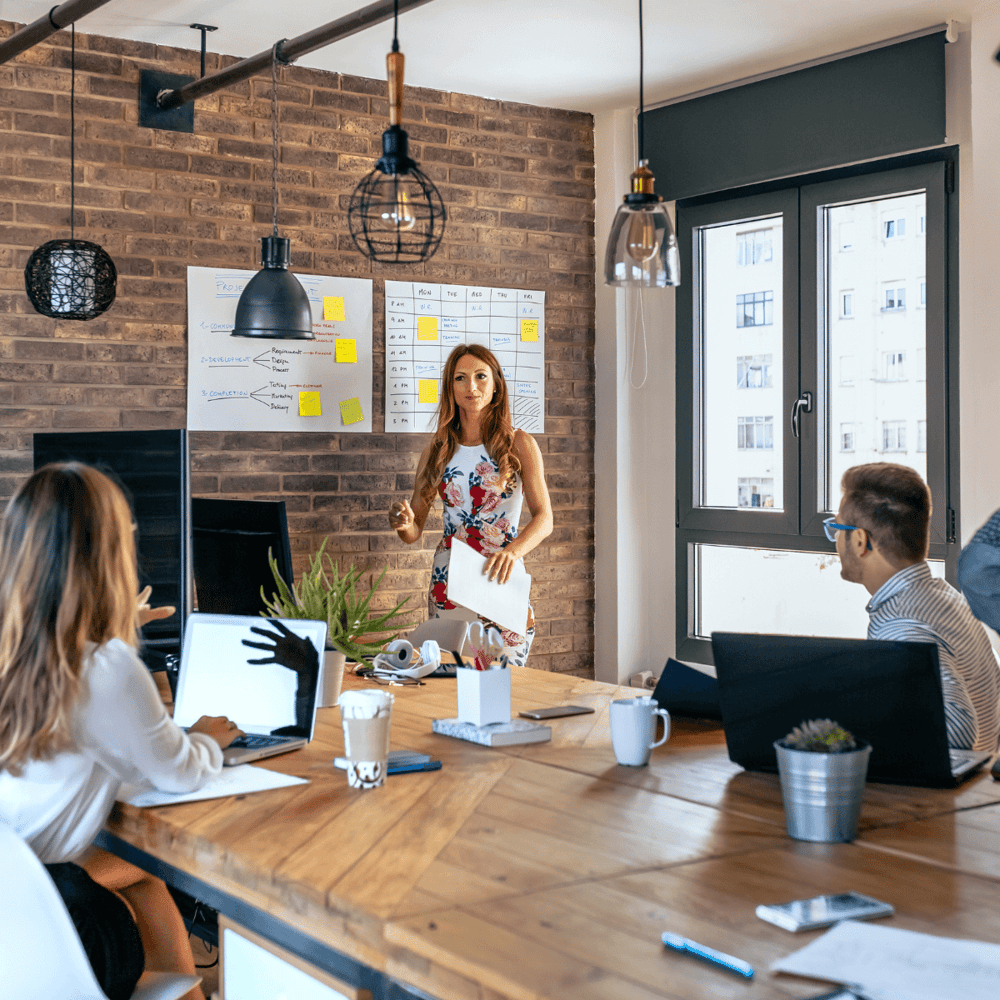 Woman giving a presentation to the rest of the board.