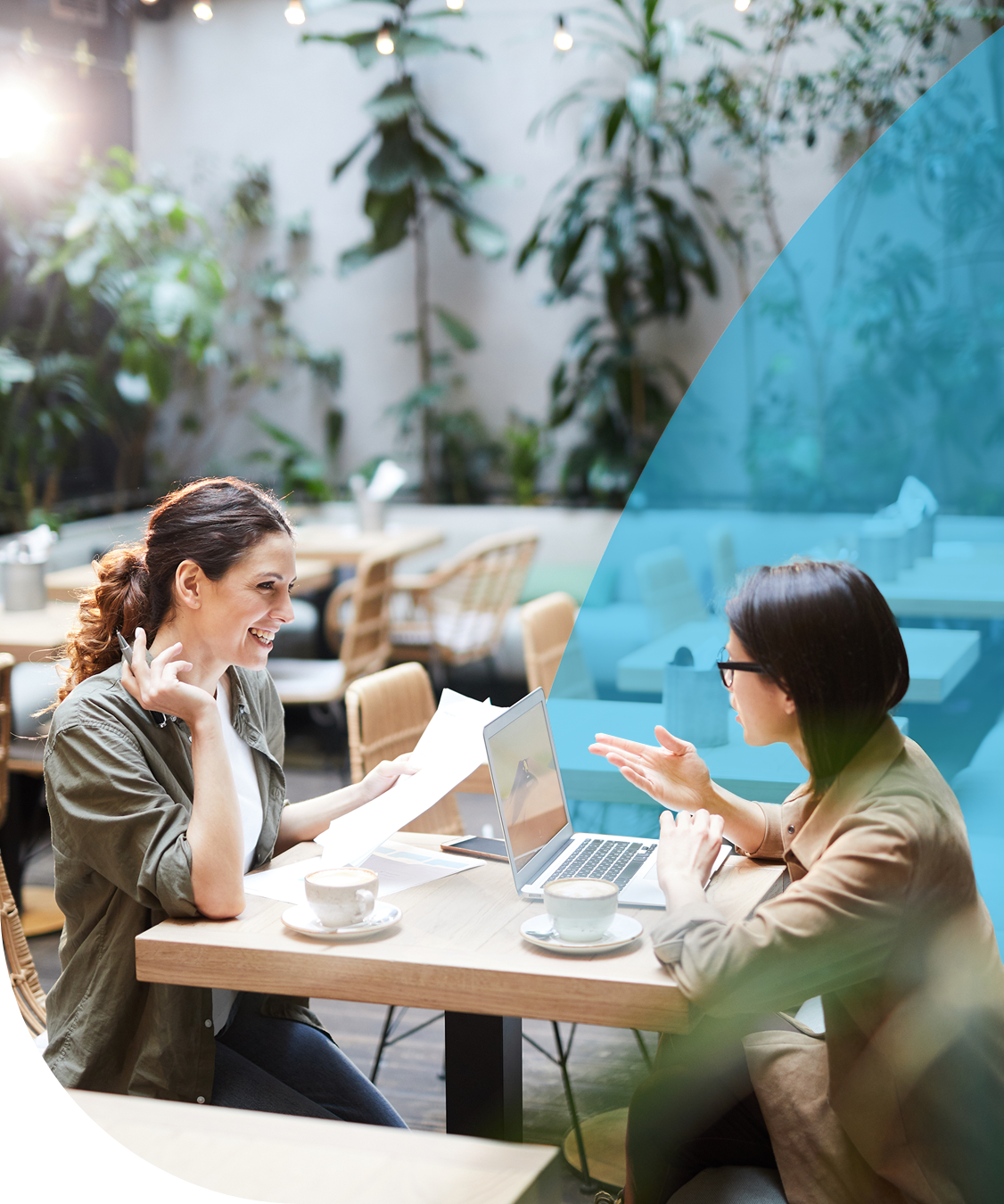 Two women conversing in a cafe.