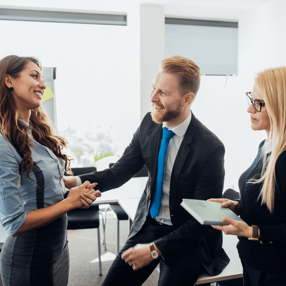 Team members in an office, engaging in conversation.