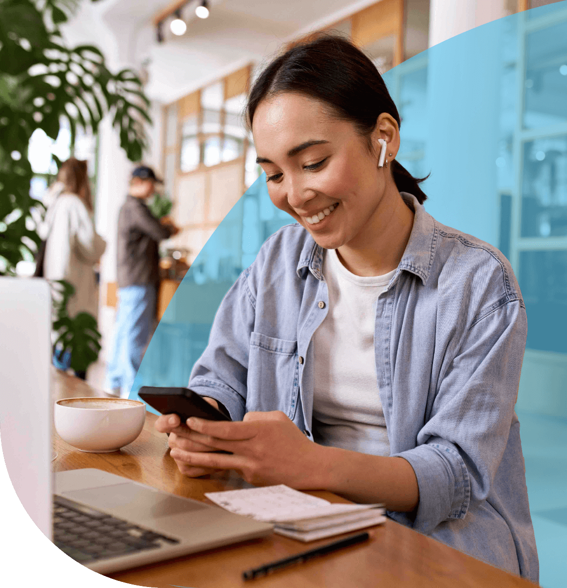 Young woman happily working at desk on her laptop.