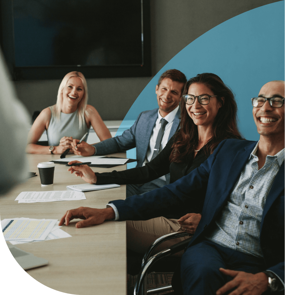 Team members sat in a meeting looking happy.