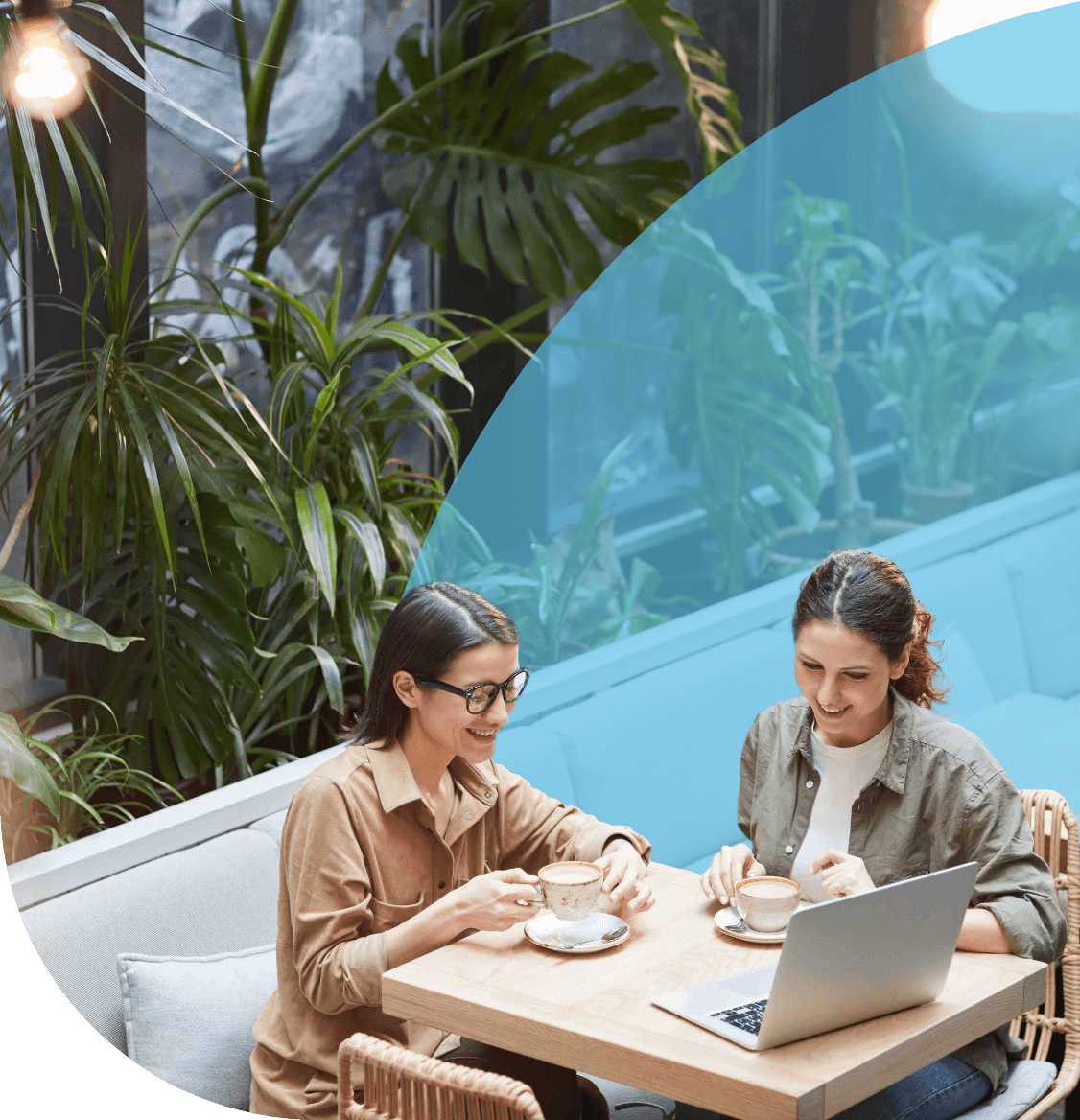 Two women having a virtual meeting in a cafe.